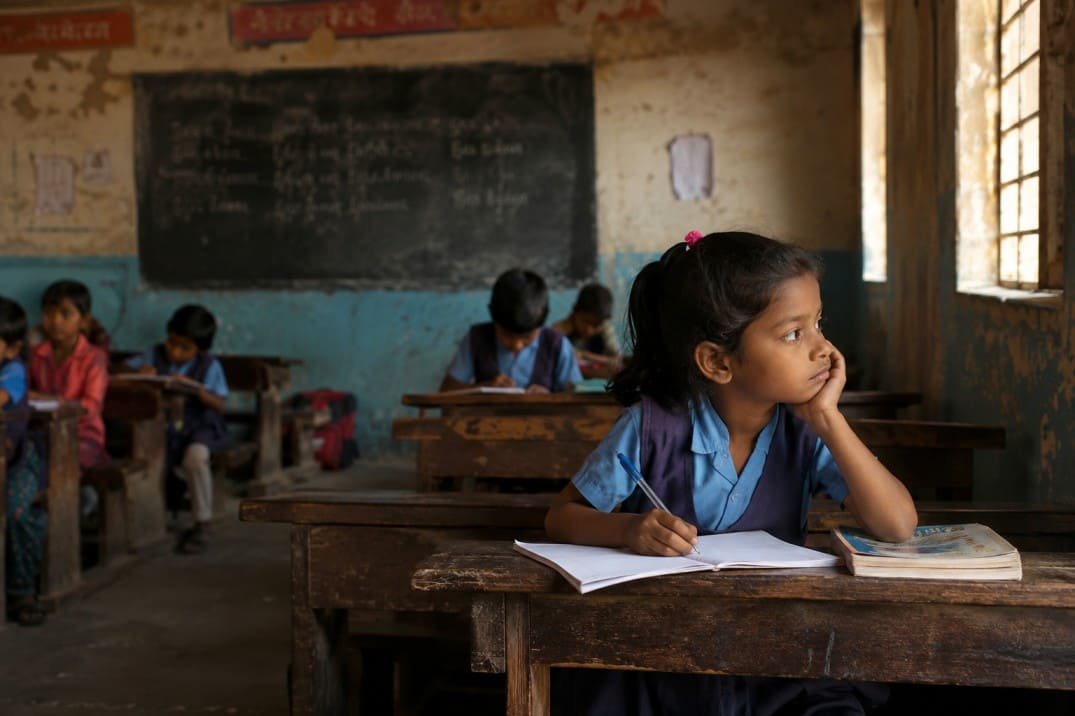 Young student studying in an under-resourced classroom highlighting the education crisis in India and learning challenges faced by school children.